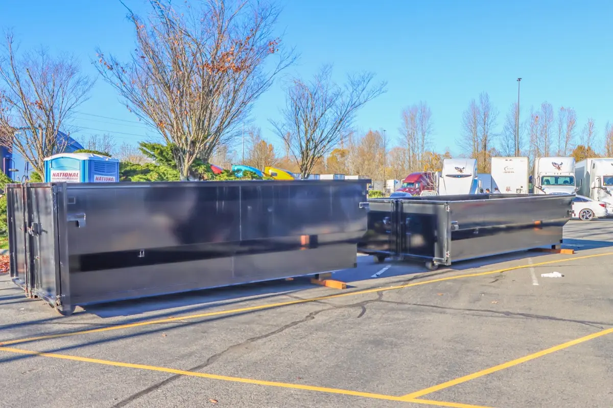 Professional dumpster rental service with roll-off container on residential driveway in Belle Isle